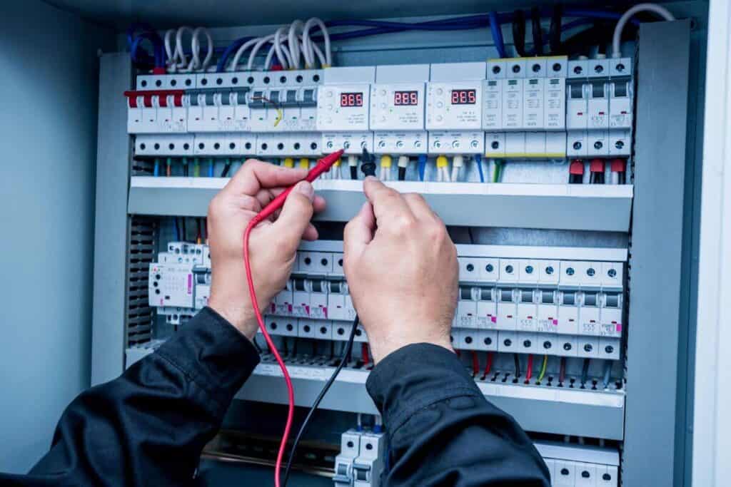 Commercial Electrician Perth WA testing circuit voltages on commercial switch board