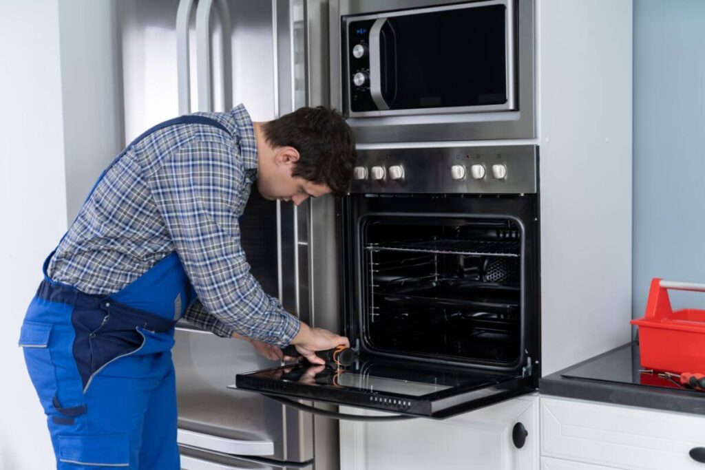Electrician near me checking internal oven parts for faults in Bassendean WA