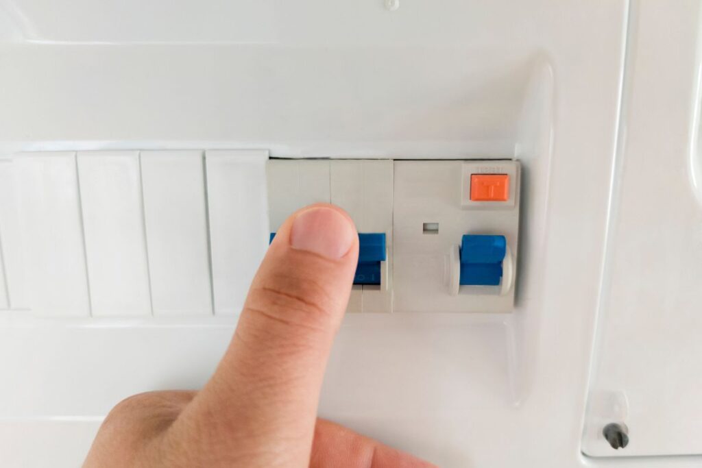 Electrician pressing RCD in Perth home